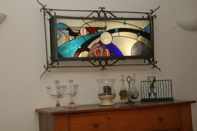 The Watcher : représentation stylisée d'une pupille. Panneau de vitrail Tiffany inséré dans une structure acier. Rétro-éclairage tubes fluo
